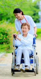 caregiver taking her patient to the park
