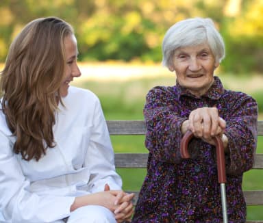 senior woman along with her caregiver smiling