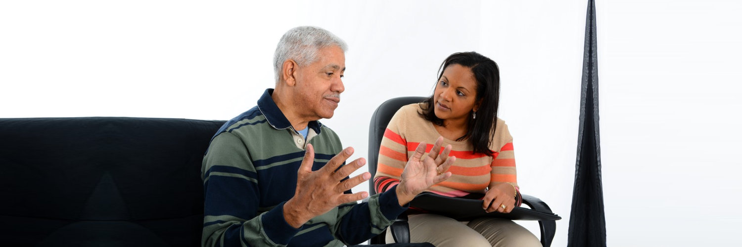 therapist asking question to a senior man